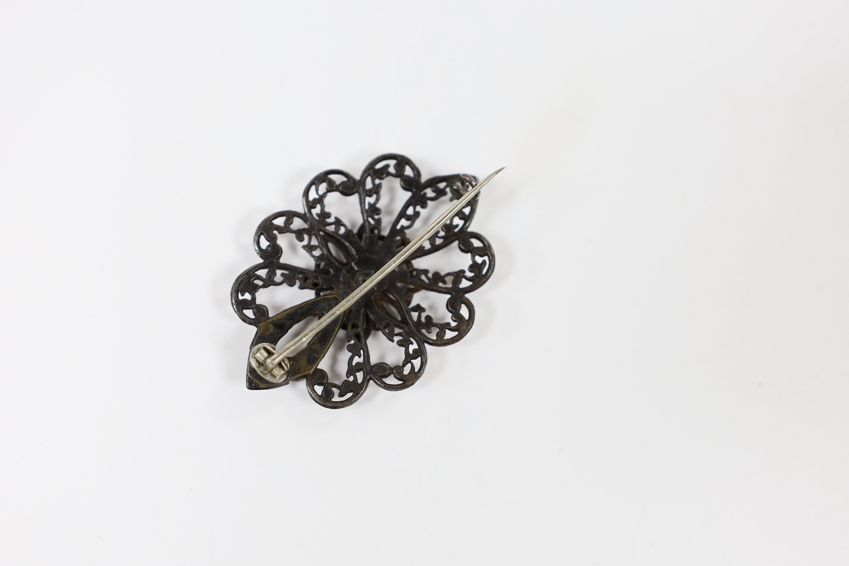 A 19th century Berlin iron work brooch, of shaped oval flower head form (repair), 49mm.